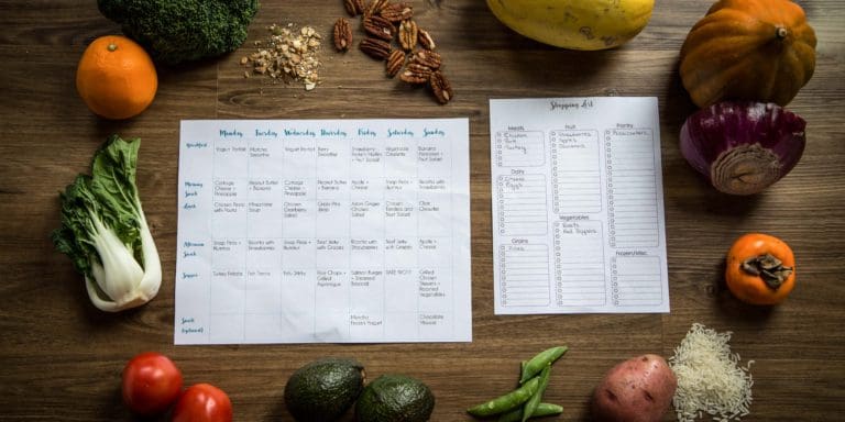 Healthy meal ingredients including fresh vegetables, grains, and spices displayed on a wooden table, representing an individualized meal plan.